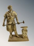 A brass figure of a blacksmith, height 20 cm.