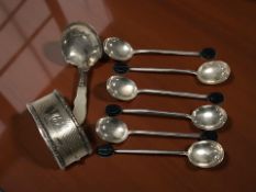 A silver napkin ring, a set of six coffee spoons and a caddy spoon with mother of pearl handle.