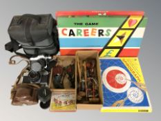 A group of cameras including Nikon, boardgames, puppets, etc.