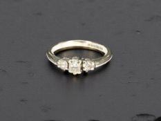 An 18ct white gold three stone diamond ring, size K½ CONDITION REPORT: 2.