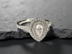An 18ct white gold pear shaped diamond cluster ring, the principal stone approximately .