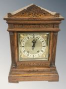 A carved eight day bracket clock, striking on a gong, with pendulum, height 42 cm.