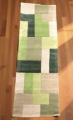 A brand new Lexus green ground 100% wool runner, 230 cm x 60 cm.