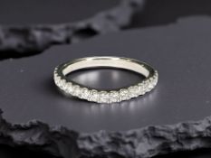 An 18ct white gold diamond half eternity ring, approximately 0.4cts, size L.