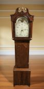 An early 19th century oak and mahogany thirty hour long case clock with painted moon phase dial