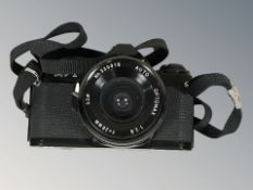 A Pentax MV1 camera, with Optomax f=28mm lens, together with a hide covered drum, height 34 cm.
