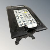 A cast iron coal receiver inset with tiles, length 53 cm.