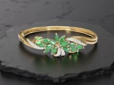 A 9ct yellow gold emerald and diamond bracelet, diameter 6 cm x 5 cm.