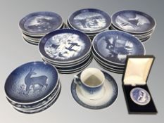 A group of Royal Copenhagen blue and white collector's plates, coffee can and saucer,