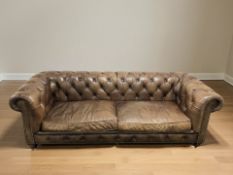 A Halo brown buttoned leather Chesterfield four seater settee, 244 cm x 98 cm x 79 cm.
