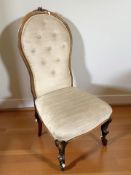 A late Victorian walnut salon chair in buttoned fabric, width 60 cm.