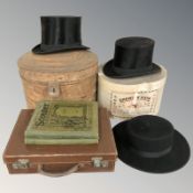 A gent's black silk top hat by John Craig, Park Row, Leeds, in tin, a further silk top hat,