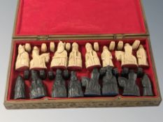 A medieval style chess set in box, kings 9 cm.