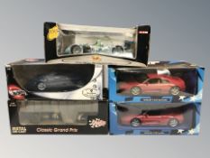 A group of boxed die cast scale model cars including Maisto and Hot Wheels.