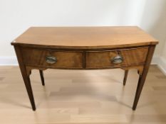A George III mahogany bow front two drawer hall table, 115 cm x 56 cm x 79 cm.