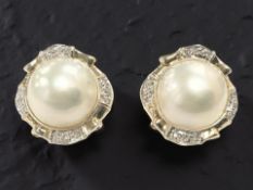 A pair of 18ct gold and diamond mabe pearl earrings, each 22mm diameter.