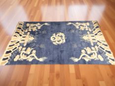 A Chinese rug depicting dragons, 224 cm x 127 cm.
