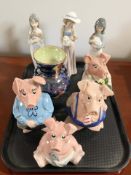 Four Wade Natwest pigs, a Maling storm vase, and three Nao figures of girls.