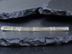 An 18ct white gold and diamond bracelet, approximately 6cts, length 19 cm, width 1 cm.