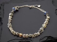 Pandora : A silver charm necklace strung with many decorative charms, length 44cm, in Pandora box.