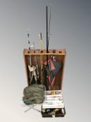 A group of various fishing rods, reel and related supplies.