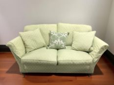 A Duresta Ruskin Victorian style three seater settee in green upholstery,