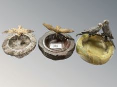 An onyx ashtray surmounted by two cold-painted metal budgies, width 13 cm,