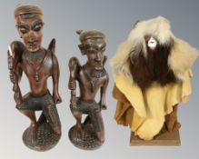 A pair of reproduction carved African figures of hunters, height 46 cm,