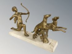 A gilt metal figure group of a huntress and hounds on stone plinth, 52 cm L x 28 cm H.