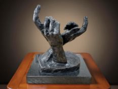 A contemporary sculpture depicting a pair of hands, on black marble plinth, 24 cm W x 28 cm H.
