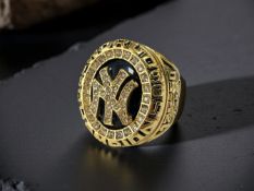 A gold-plated and encrusted Superbowl style ring, size P.