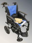 A G-Logic electric wheelchair with lead, instructions, etc.