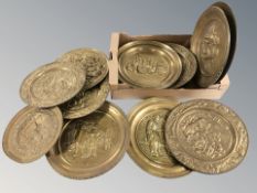 A quantity of embossed brass chargers.