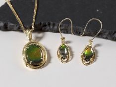 A 14ct gold ammolite pendant within an oval yellow metal setting, length 3cm,