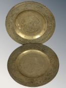 A pair of oriental embossed brass dishes, diameter 25 cm.