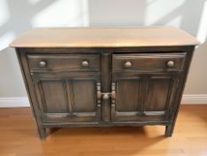 An Ercol stained elm sideboard, 123 cm x 49 cm x 85 cm.