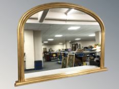 A Victorian style domed gilt over mantel mirror, 113 cm x 80 cm.
