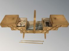 A concertina sewing box and contents.