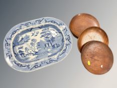A blue and white willow pattern meat plate, width 44 cm, and a group of six African wooden plates.