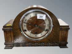 A 1920s carved oak eight day mantel clock, height 21 cm.