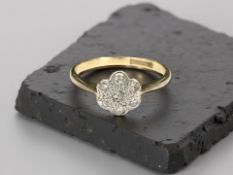 An 18ct yellow gold diamond daisy cluster ring, size M. CONDITION REPORT: Weight: 2g.