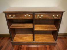 A reproduction mahogany two drawer bookcase, 107 cm x 31 cm x 84 cm.