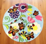 A brand new children's floral patterned circular rug, diameter 150 cm.