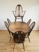 An Ercol stained elm oval extending dining table, 150 cm x 98 cm x 73 cm,