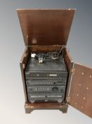 A reproduction audio cabinet containing Aiwa and Matsui hi-fi separates.