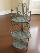 A painted wrought metal three corner whatnot stand, height 118 cm.