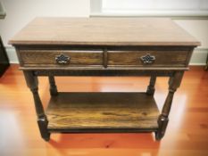 A reproduction oak two drawer side table, 95 cm x 45 cm x 82 cm.