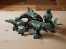 A group of Canadian Blue Mountain pottery animal ornaments including leaping dolphin, bears, geese,