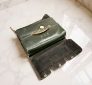 A Harrods green leather travelling set with silver mounts