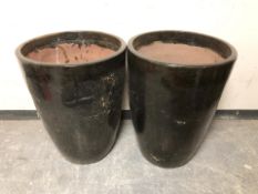 A pair of black glazed earthen ware garden planters,